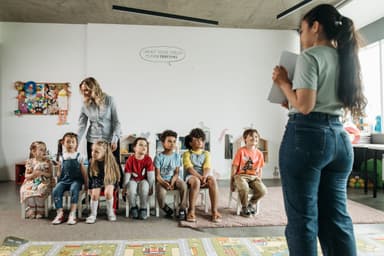 Educators working with a diverse group of preschool children